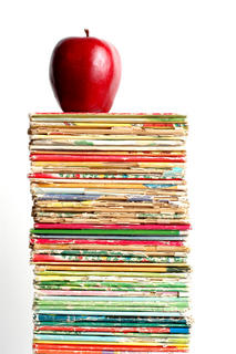 Stack of books with apple on top