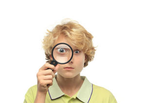 Boy looking through magnifying glass