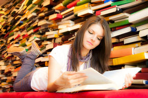 Young girl reading in library