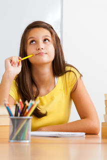 girl sitting at desk writing