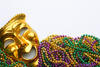 Gold mask and mardi gras beads
