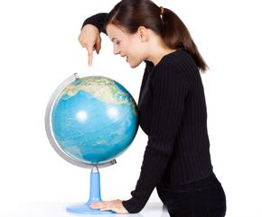 Girl pointing to a globe