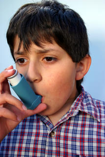 Boy with asthma inhaler