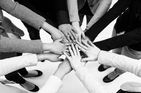 women putting their hands together