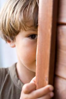 young boy hiding