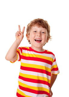 Young boy holding up a peace sign