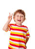 Young boy holding up a peace sign