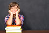 School boy with arms resting on books