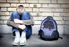 boy sitting against a wall with his head in his hands