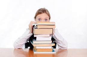 girl resting head on stack of books