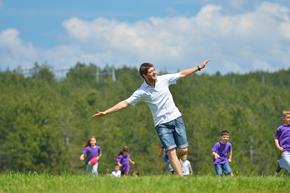 teacher playing outside with students